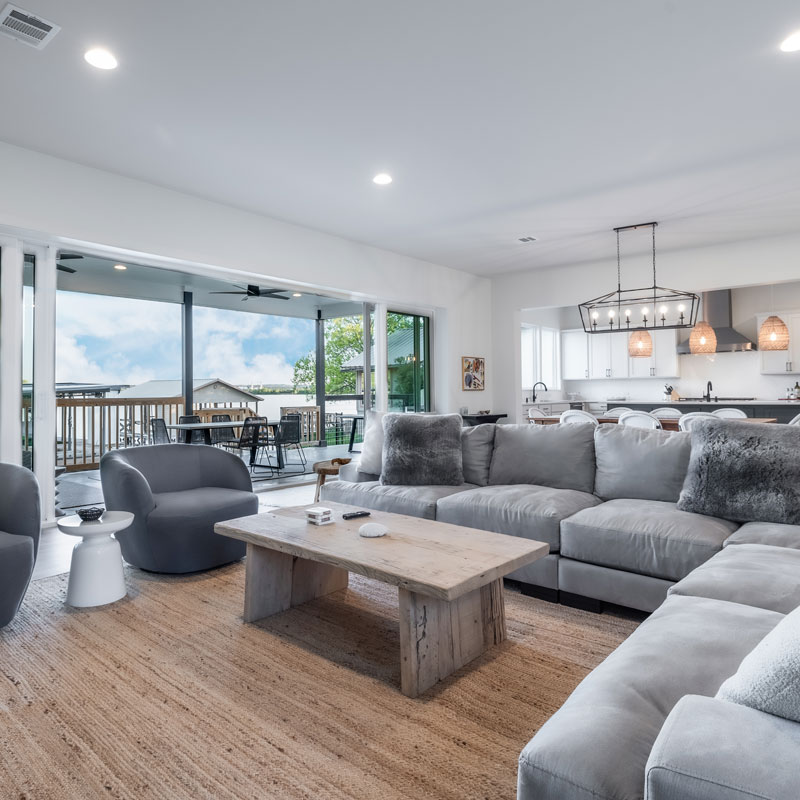 Christopher-Custom-Homes-Modern-Farmhouse-Lake-Front-Home-Main-Living-Area-Open-to-Outdoor-Living-Lake-VIew-Granite-Shoals-Custom-Home-Builder