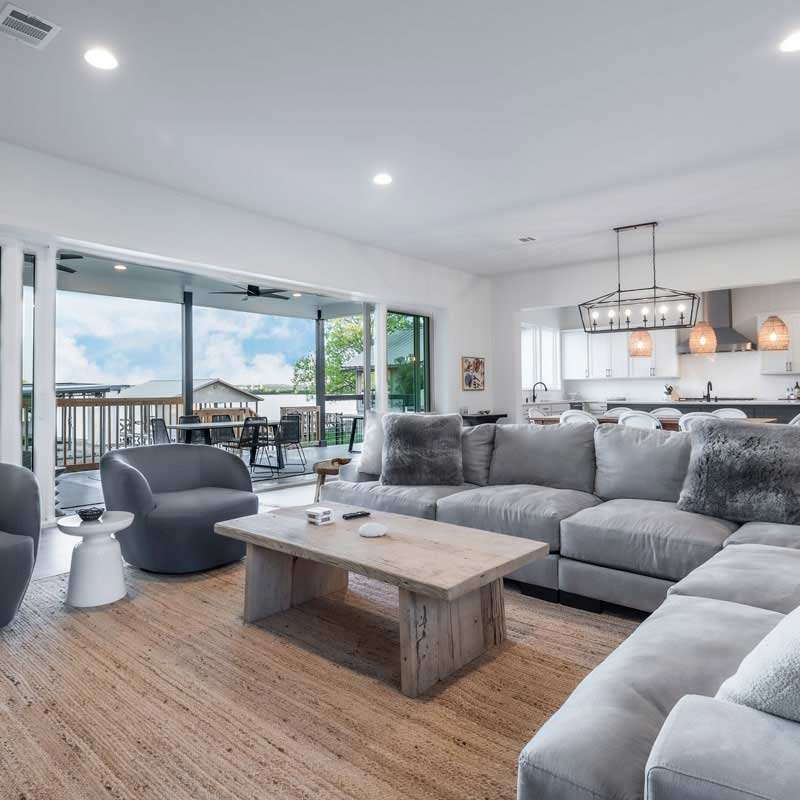 Christopher-Custom-Homes-Modern-Farmhouse-Lake-Front-Home-Main-Living-Area-Open-to-Outdoor-Living-Lake-VIew-Granite-Shoals-Custom-Home-Builder