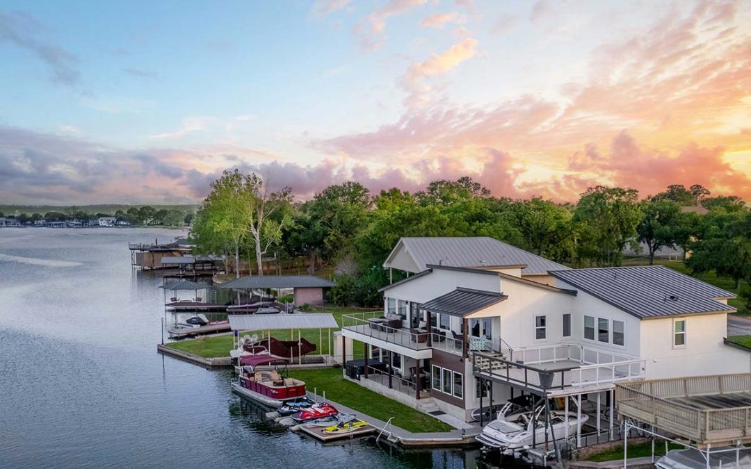 Texas Hill Country home builders showcasing a luxury waterfront residence with private dock and multi-level outdoor living on Lake LBJ.